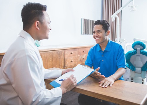 dentist talking to patient about cost of tooth extraction