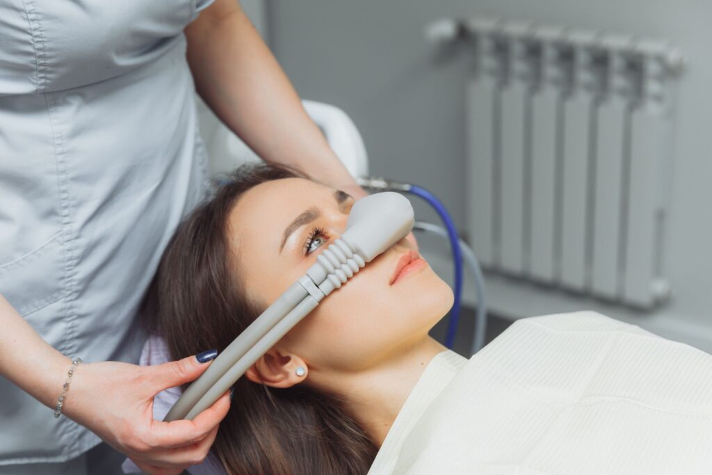 Woman in dental chair with nitrous oxide mask over nose